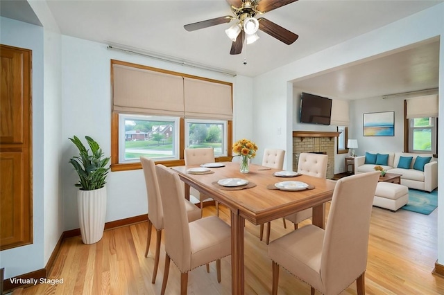 102 Olive Dr, Level Green, PA 15085 - dining space with light wood finished floors, plenty of natural light, baseboards, and a fireplace