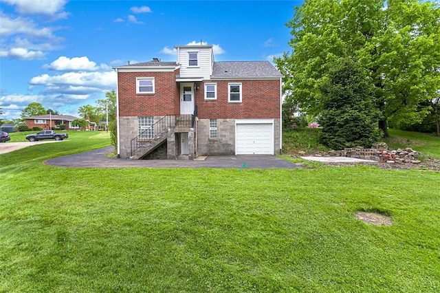 102 Olive Dr, Level Green, PA 15085 - back of property featuring a garage, a yard, asphalt driveway, brick siding, and stairs