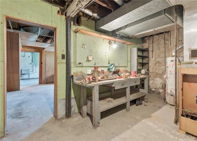 unfinished basement with a workshop area and water heater