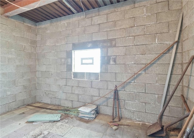 bathroom featuring concrete block wall