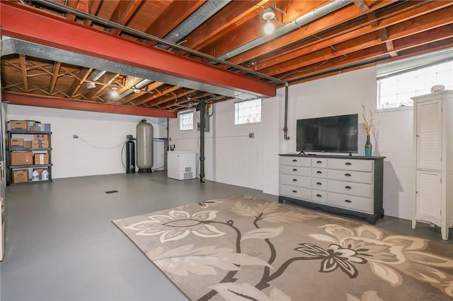 below grade area featuring plenty of natural light and a water softener