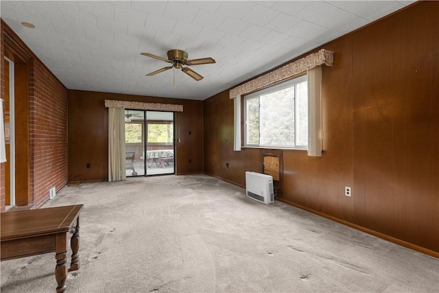 677 Olive St, Mccandless, PA 15237 - unfurnished room featuring a ceiling fan, light carpet, wood walls, heating unit, and baseboards