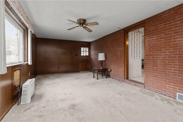 677 Olive St, Mccandless, PA 15237 - carpeted spare room with ceiling fan, brick wall, and wood walls