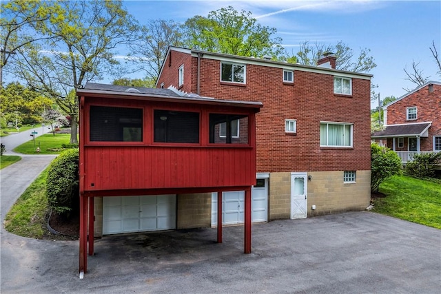 677 Olive St, Mccandless, PA 15237 - rear view of property featuring a garage, a chimney, and brick siding