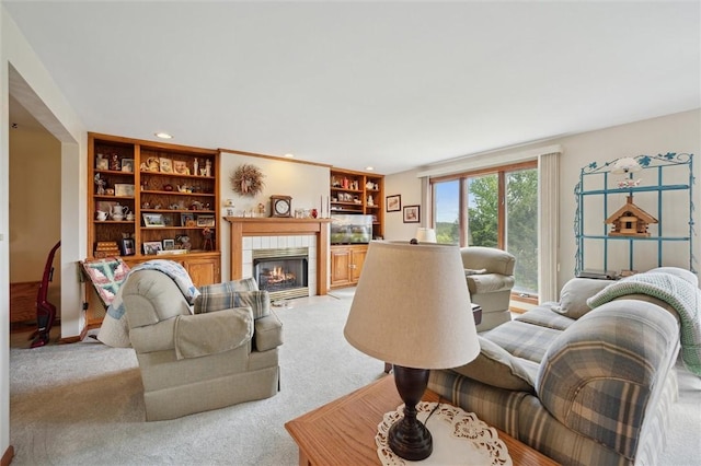 living area with a fireplace, light colored carpet, and recessed lighting