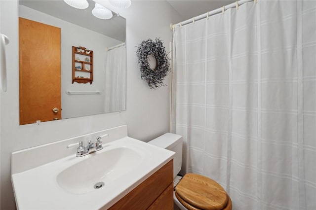 bathroom with toilet and vanity