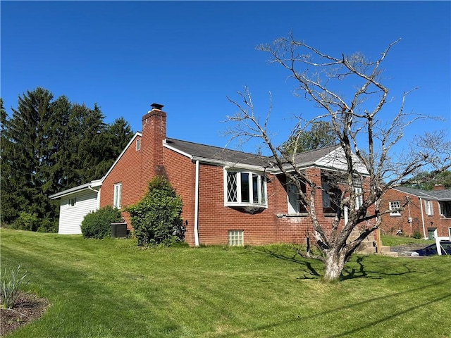316 Franklin Dr, Peters Twp, PA 15241 - view of home's exterior featuring brick siding, a chimney, and a lawn
