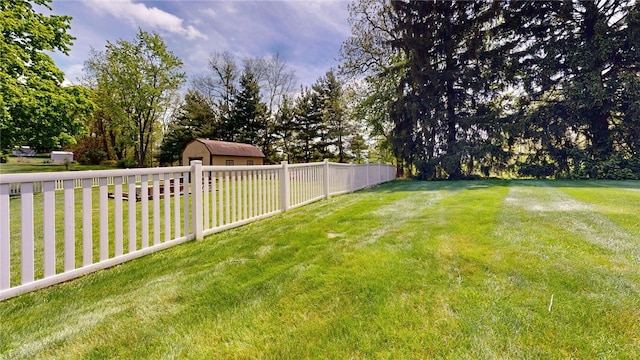 view of yard with view of wooded area