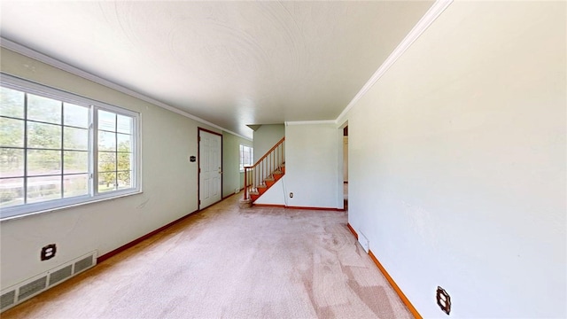unfurnished living room featuring light carpet, ornamental molding, baseboards, and stairway