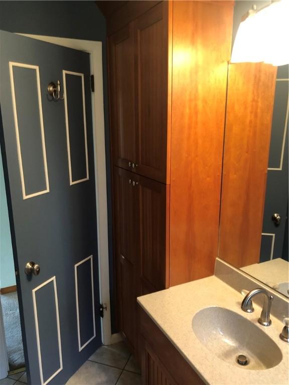 bathroom with tile patterned flooring and vanity