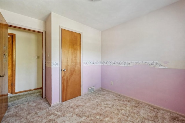 unfurnished bedroom featuring carpet flooring and baseboards