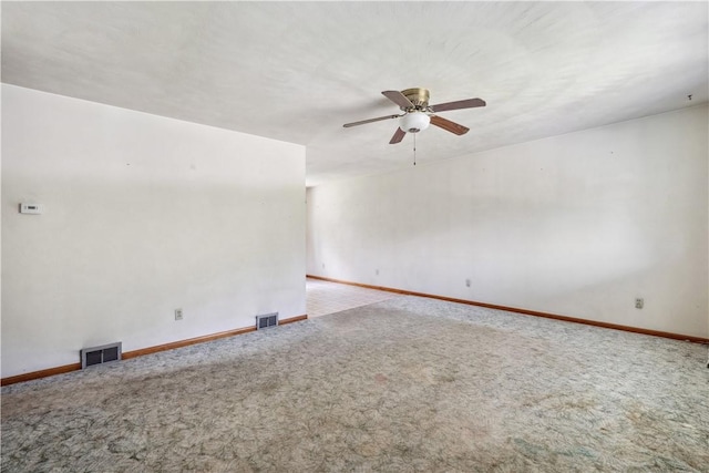 spare room with carpet flooring, a ceiling fan, and baseboards