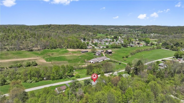 aerial view of property's location featuring a heavily wooded area