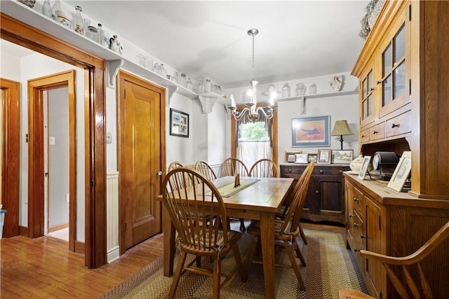 dining space featuring a chandelier and wood finished floors