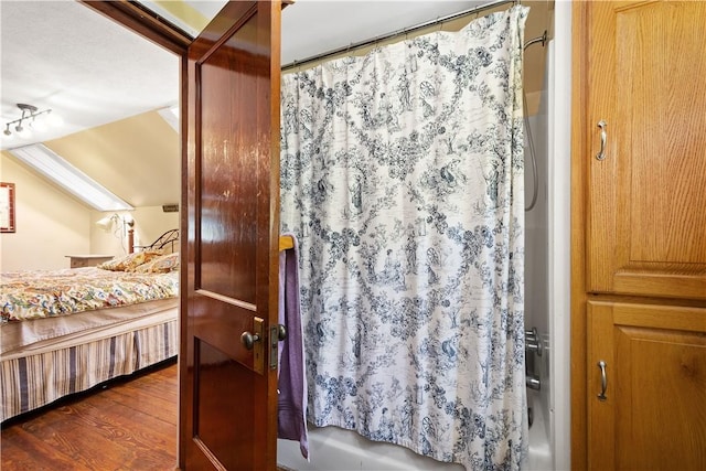 bedroom with dark wood-style flooring