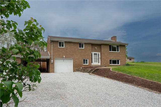 split foyer home featuring driveway, a chimney, brick siding, an attached garage, and a front lawn