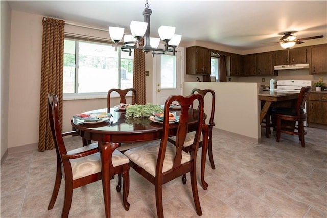 dining room with a chandelier, ceiling fan, and baseboards