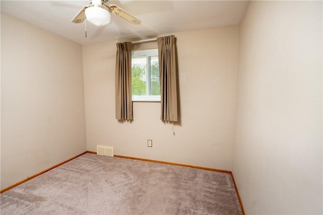 unfurnished room with baseboards, carpet flooring, and a ceiling fan
