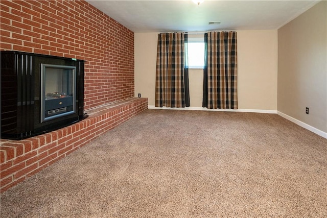 unfurnished living room with baseboards, carpet, and brick wall