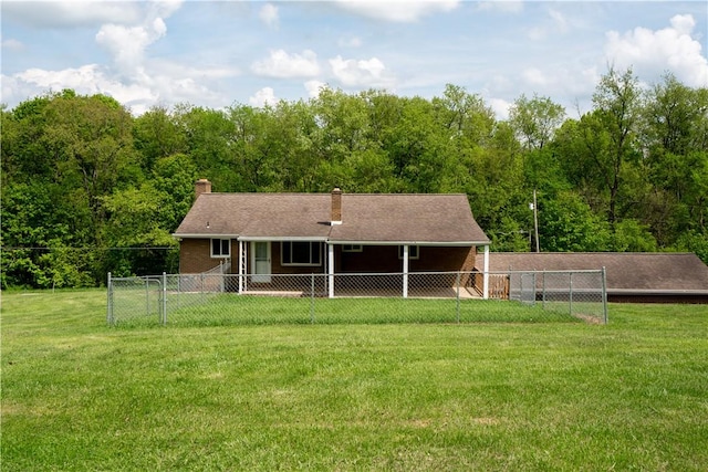 rear view of house featuring a chimney and a forest view