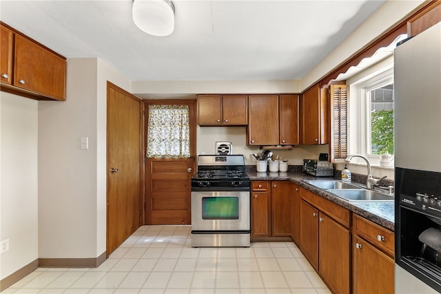 2228 Walton Ave, Overbrook, PA 15210 - kitchen featuring stainless steel gas range oven, fridge with ice dispenser, a sink, and brown cabinetry