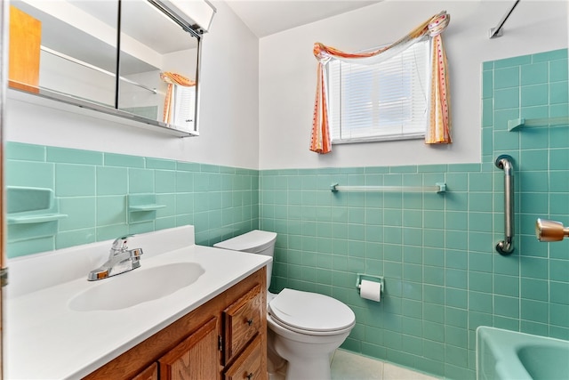 2228 Walton Ave, Overbrook, PA 15210 - full bath with tile walls, tile patterned flooring, toilet, a wainscoted wall, and vanity