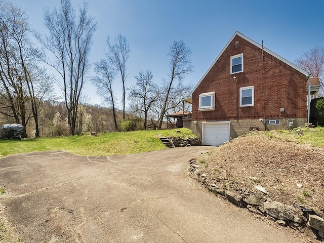 170 Millerstown Culmerville Rd, West Deer, PA 15084 - view of side of property featuring asphalt driveway, an attached garage, brick siding, and a yard