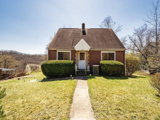 170 Millerstown Culmerville Rd, West Deer, PA 15084 - cape cod-style house featuring brick siding, a chimney, and a front lawn