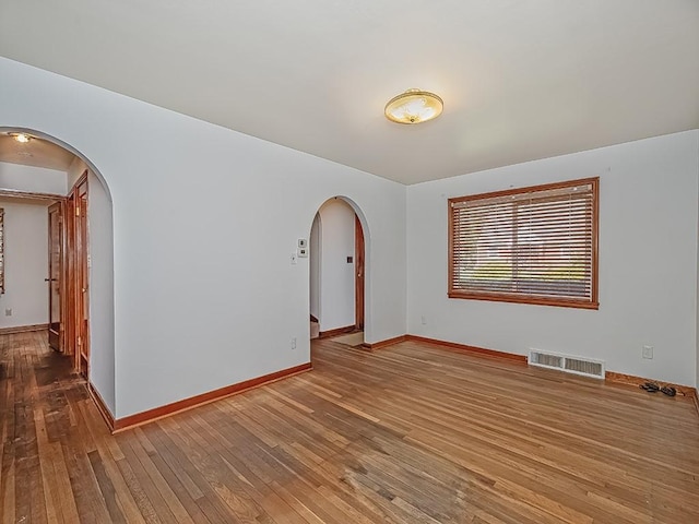 170 Millerstown Culmerville Rd, West Deer, PA 15084 - unfurnished room with arched walkways, hardwood / wood-style flooring, and baseboards
