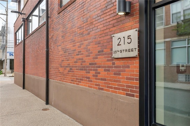 view of side of home with brick siding