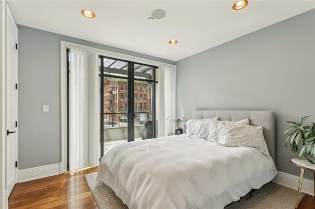 bedroom with baseboards, access to exterior, wood finished floors, and recessed lighting