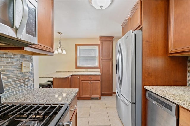 9235 Mary Ave, Mccandless, PA 15237 - kitchen with appliances with stainless steel finishes, backsplash, brown cabinetry, and light stone countertops