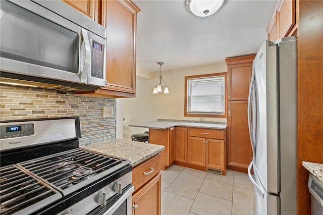 9235 Mary Ave, Mccandless, PA 15237 - kitchen with stainless steel appliances, backsplash, light tile patterned floors, and light stone countertops