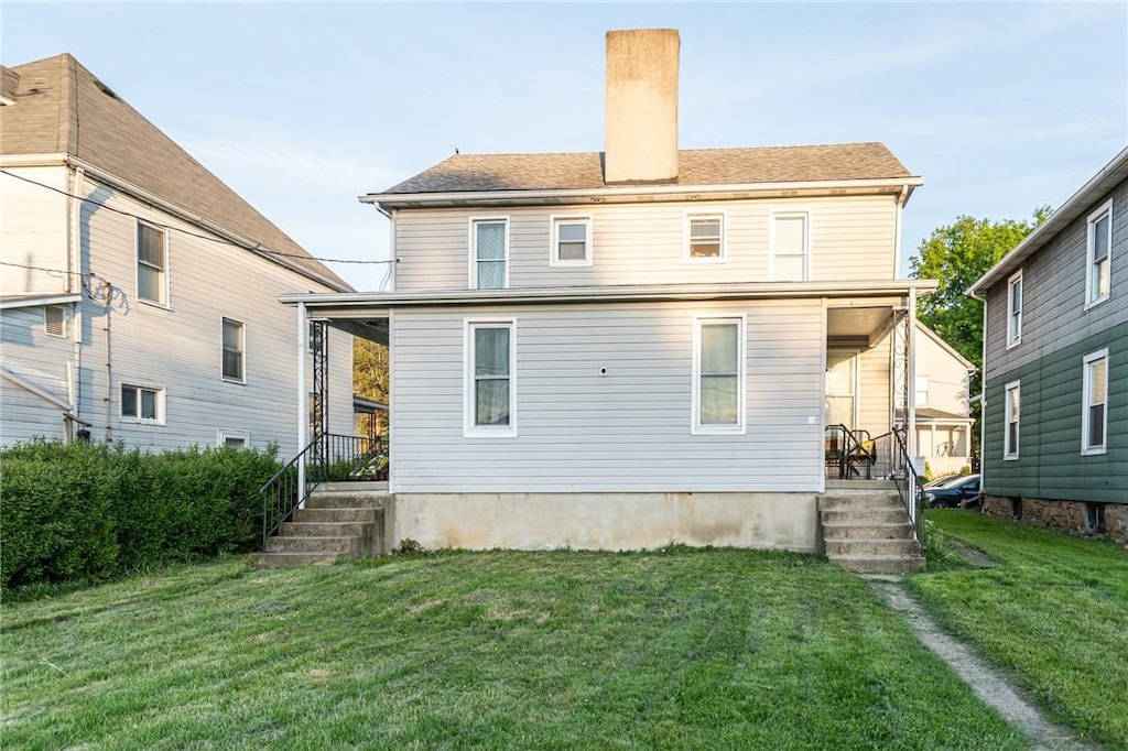 410/4101/2 Stephens St, Connellsville, PA 15425 - rear view of house with covered porch, a chimney, and a lawn