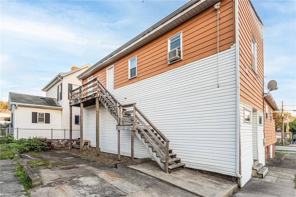 302 E Washington Ave, Connellsville, PA 15425 - back of property featuring stairs, fence, and cooling unit