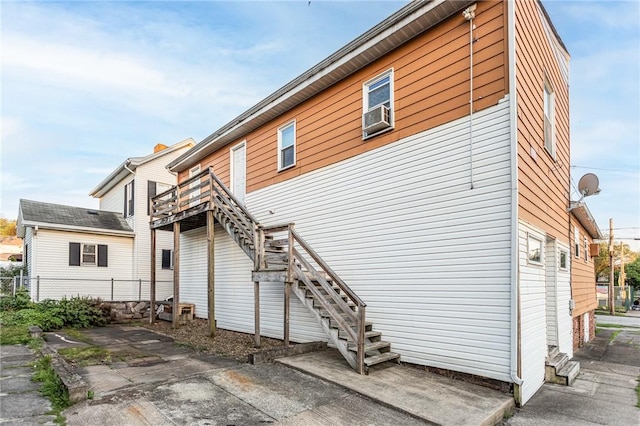 302 E Washington Ave, Connellsville, PA 15425 - back of property featuring stairs, fence, and cooling unit