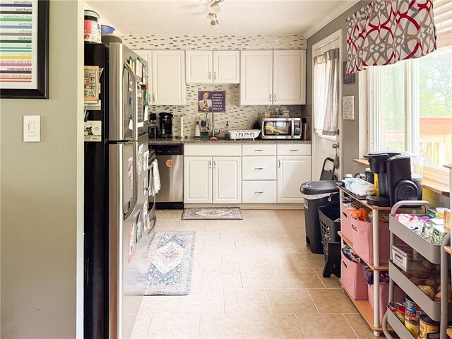 829 Cottonwood Dr, Monroeville, PA 15146 - kitchen with stainless steel appliances, plenty of natural light, white cabinets, and decorative backsplash