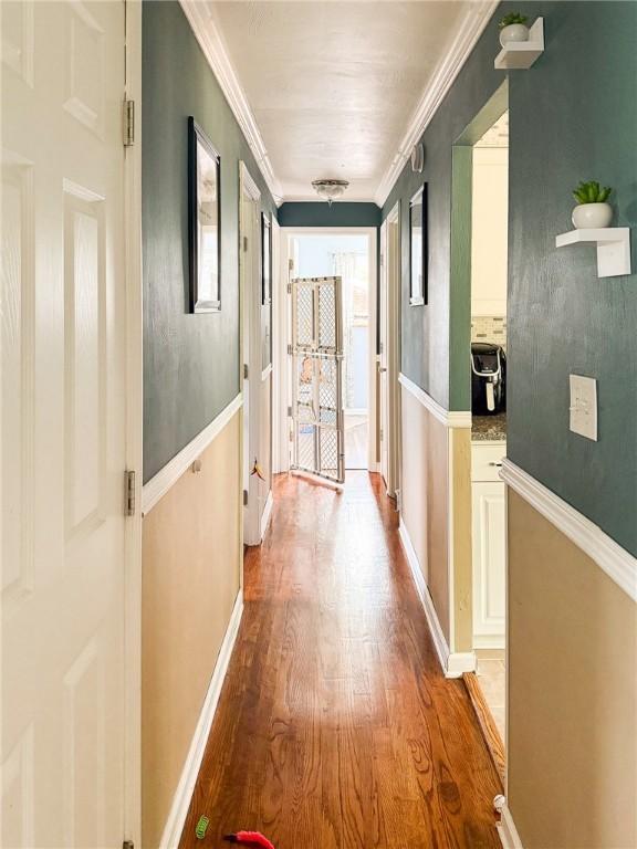 829 Cottonwood Dr, Monroeville, PA 15146 - corridor with light wood-style flooring, ornamental molding, and baseboards