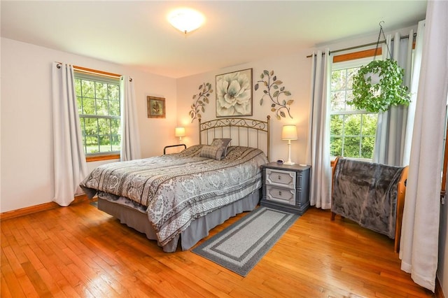 bedroom featuring light wood-style flooring and baseboards