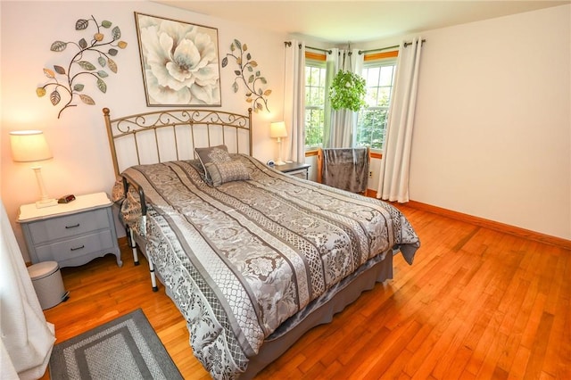 bedroom featuring light wood-type flooring and baseboards
