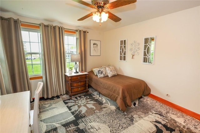 bedroom featuring baseboards, ceiling fan, and carpet floors