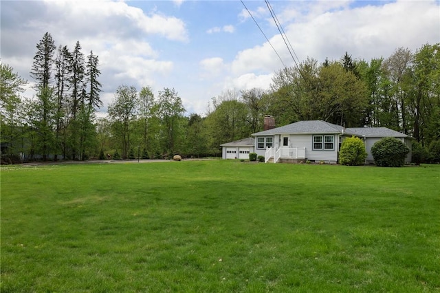 view of grassy yard with a garage