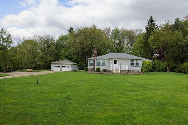 view of front of home featuring a garage, a chimney, a front lawn, an outdoor structure, and view of scattered trees