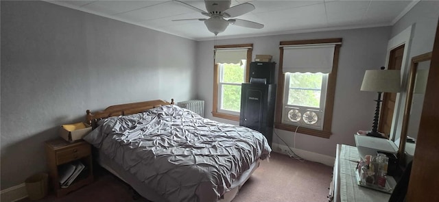 carpeted bedroom with radiator, crown molding, a ceiling fan, and baseboards