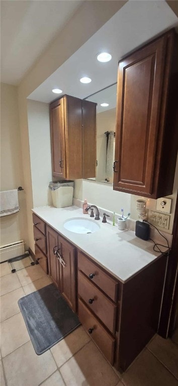 bathroom with a baseboard radiator, tile patterned flooring, vanity, and recessed lighting