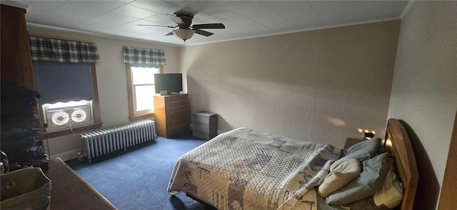bedroom with radiator heating unit, carpet, crown molding, and a ceiling fan