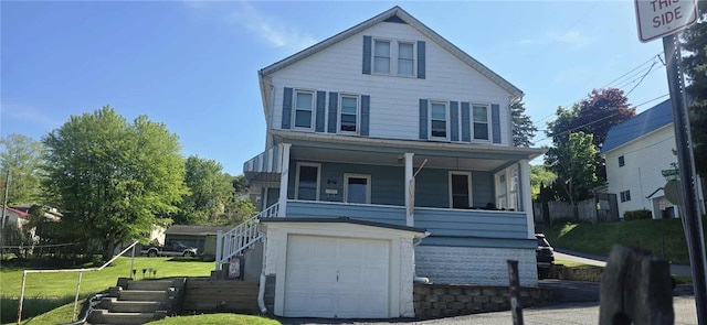 view of front of property featuring an attached garage, a front yard, stairs, and a porch