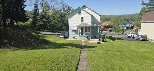 back of property featuring a lawn