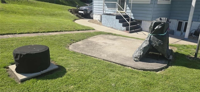 view of grassy yard featuring entry steps