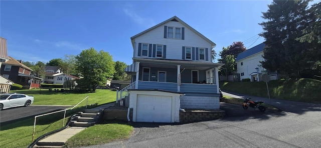 view of front of house with stairs, a front yard, an attached garage, and a residential view